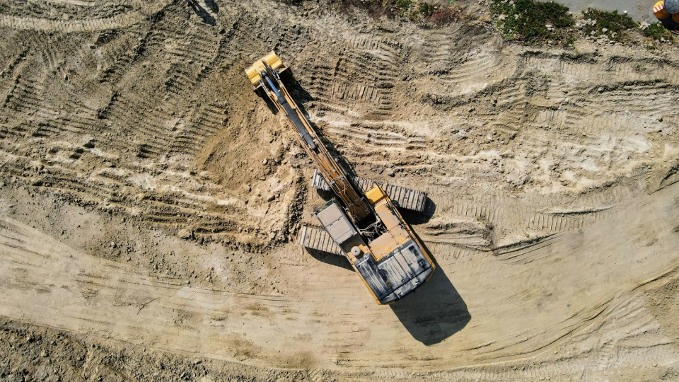 Aerial view of excavator digging dirt