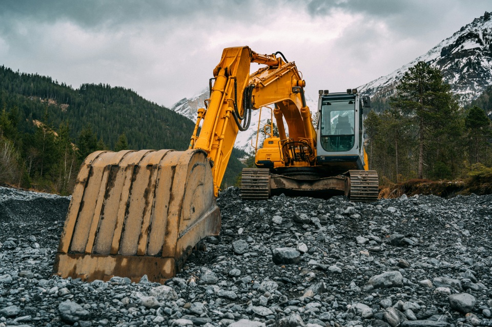 Excavator working in a rocky mountain area