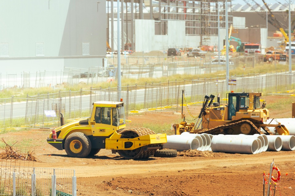 Heavy machinery and pipes on construction site