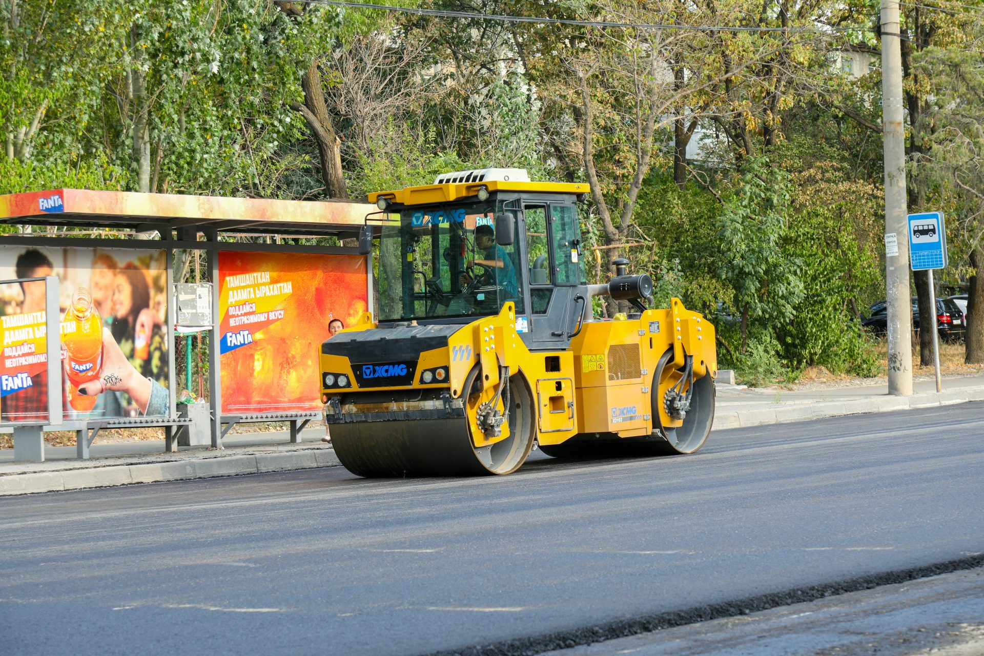 A yellow bulldozer is parked on the side of the road